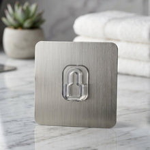 Plastic wall hook installed in bathroom for towels