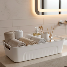 Side view of stackable white plastic storage baskets