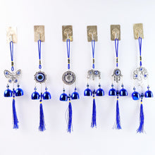 Detailed view of evil eye metal bell wind chime for house protection